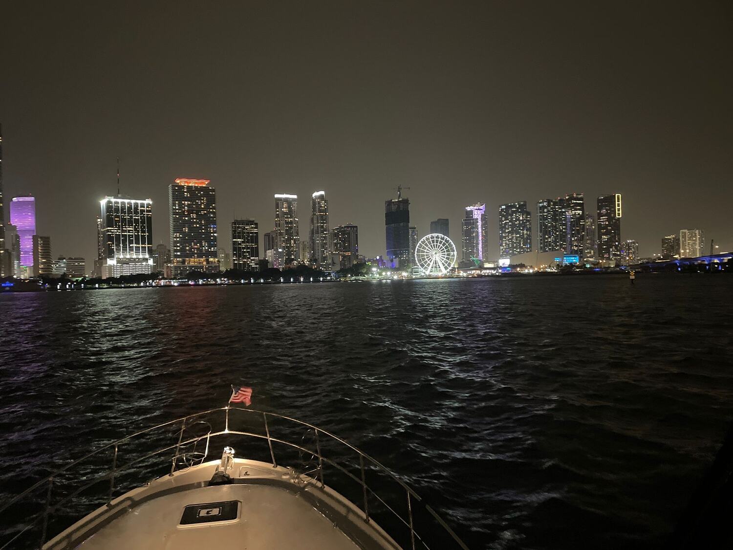 Downtown Miami skyline lit up at night seen from the bow