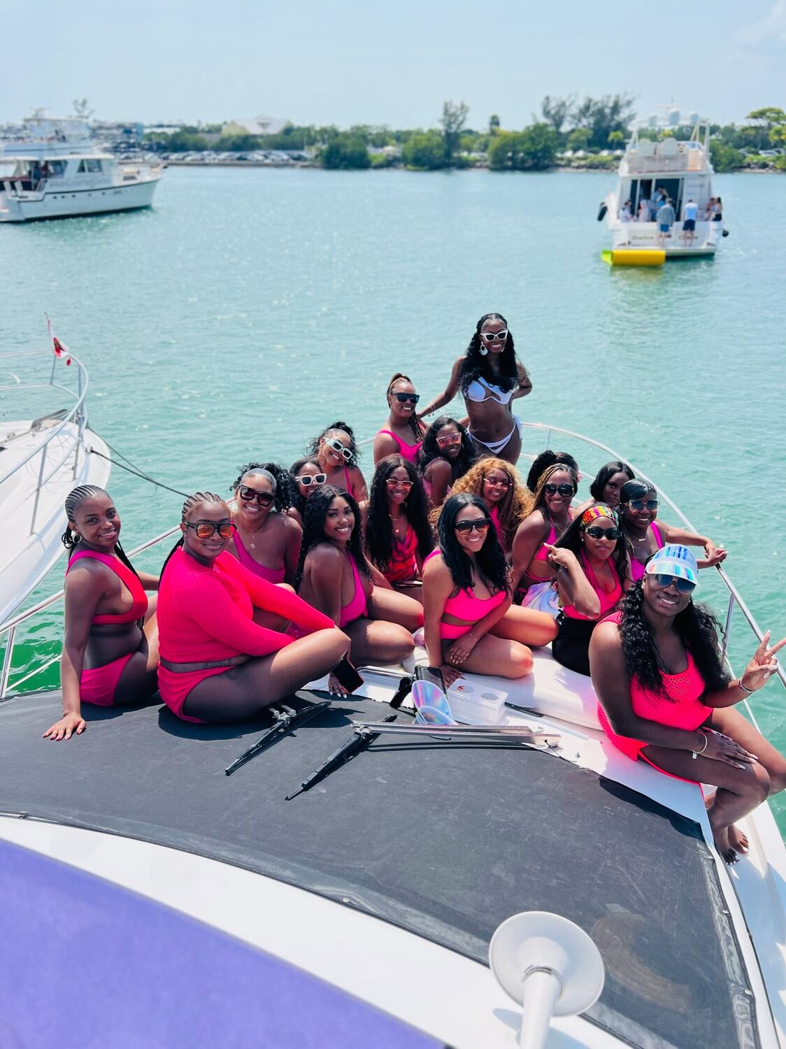 A big group in matching pink posing on the bow
